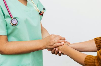 Nurse holding patients hand