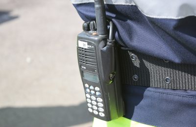 Close-up of a radio set strapped to worker